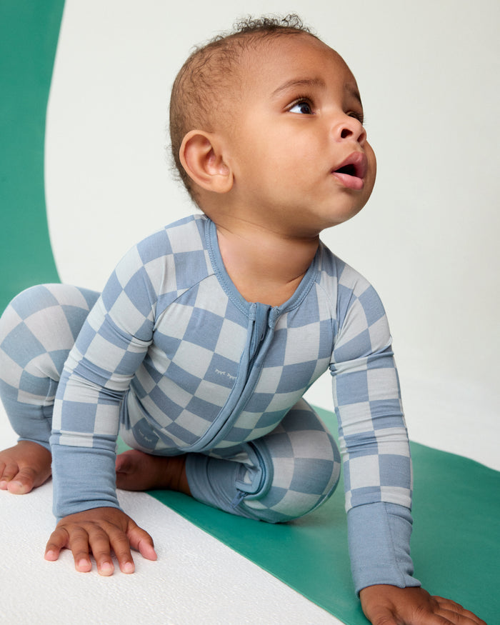 Crawling baby wearing the Dusk Blue Checks Zippy