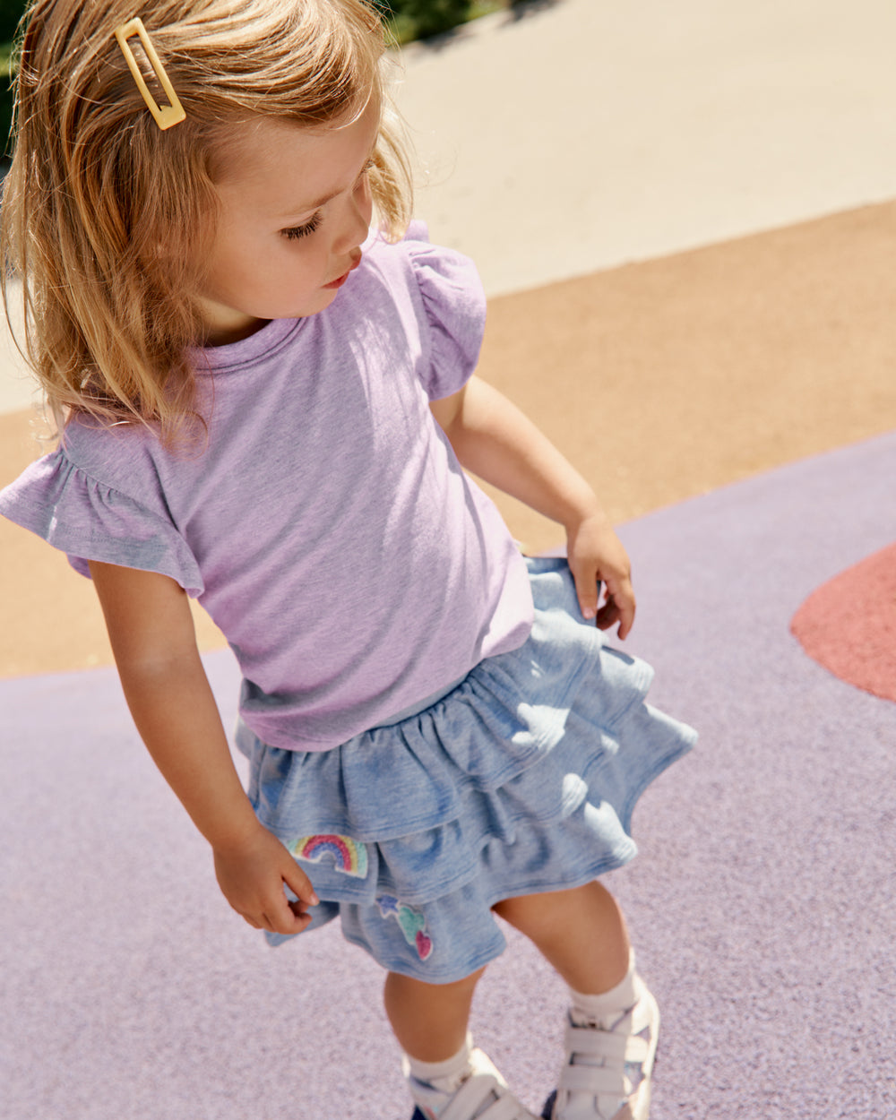 Girl wearing the Smiley Face Tiered Skort with a purple tee