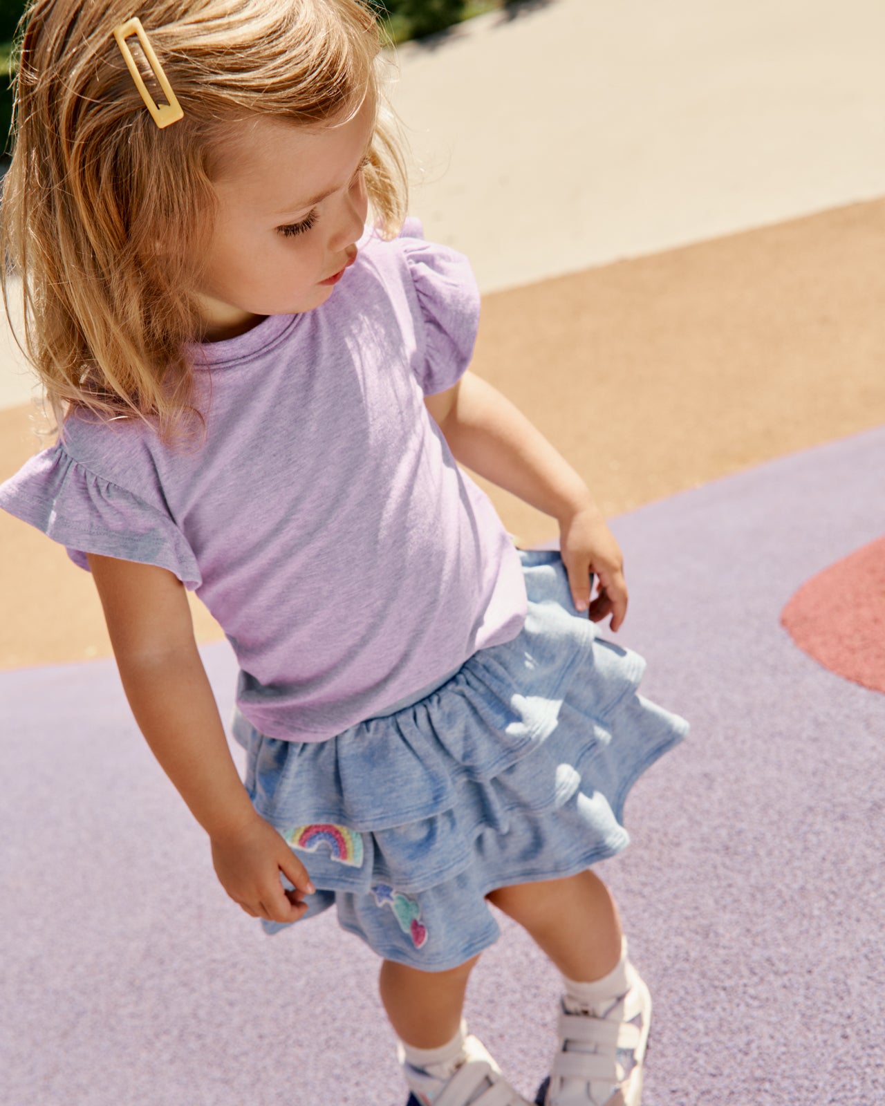 Girl wearing the Smiley Face Tiered Skort with a purple tee