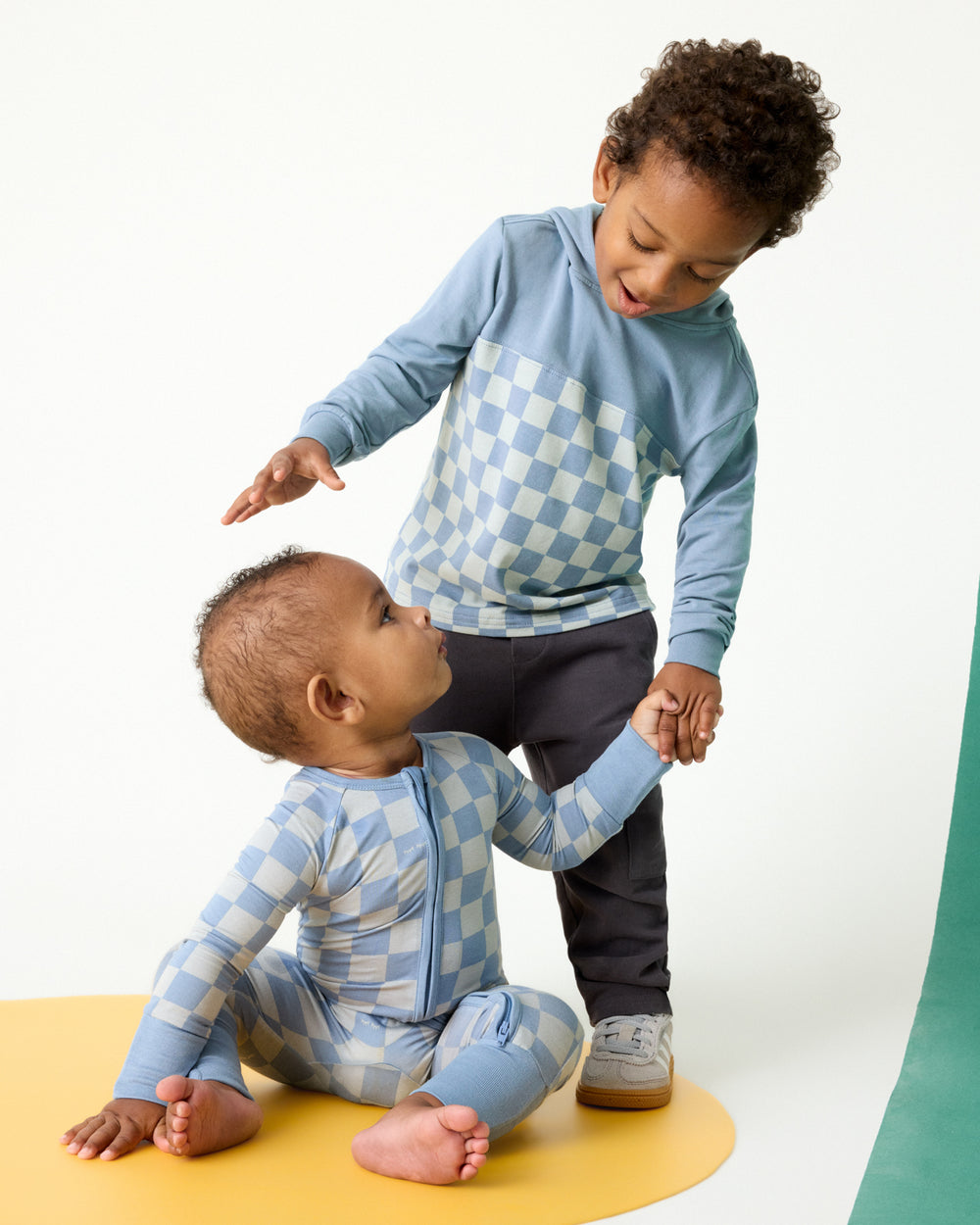 Two children wearing matching Dusk Blue Checks styles