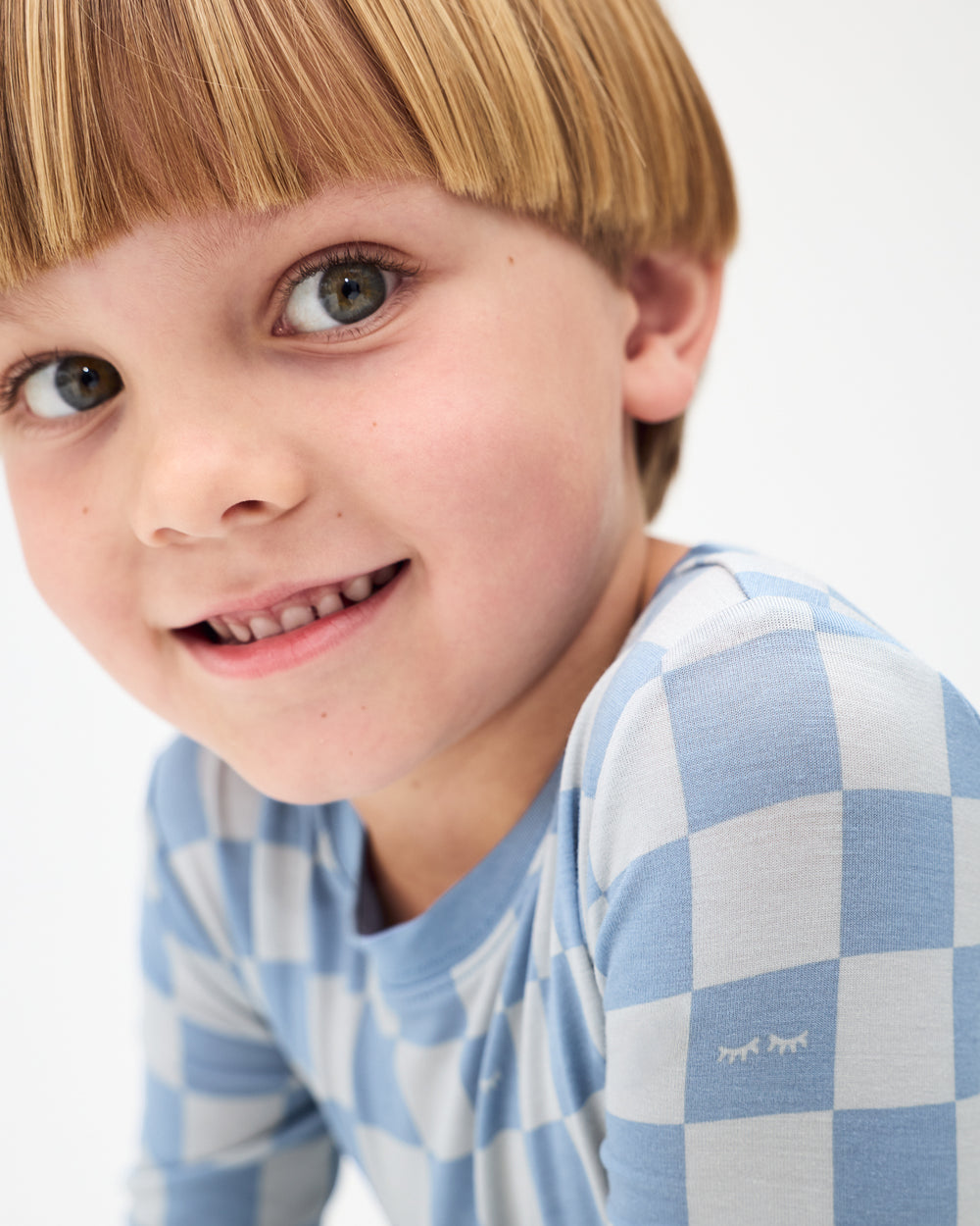 Close up of boy wearing the Dusk Blue Checks Two-Piece Pajama Set