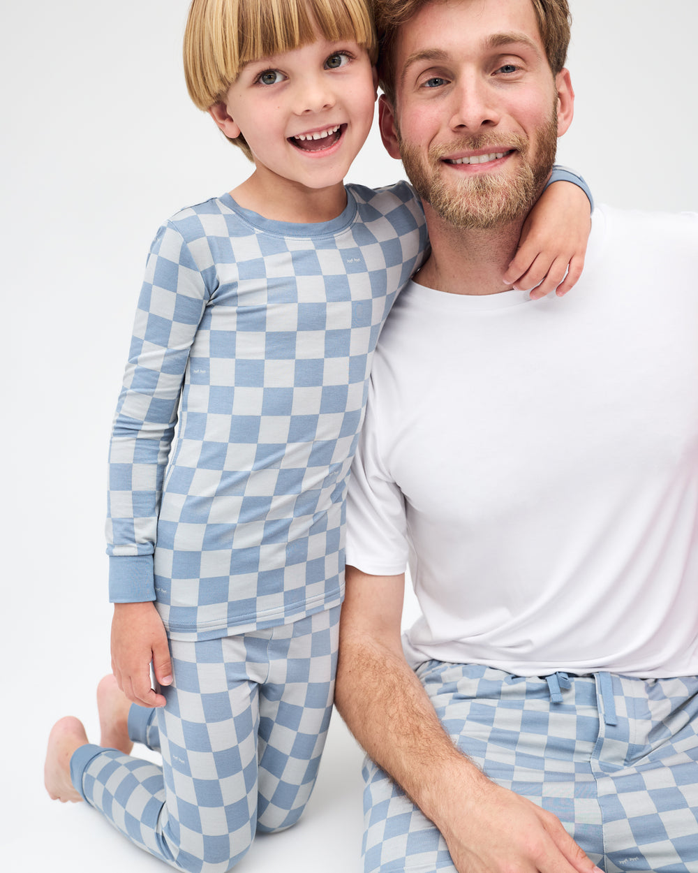 Father and son wearing matching Dusk Blue Checks Pajamas