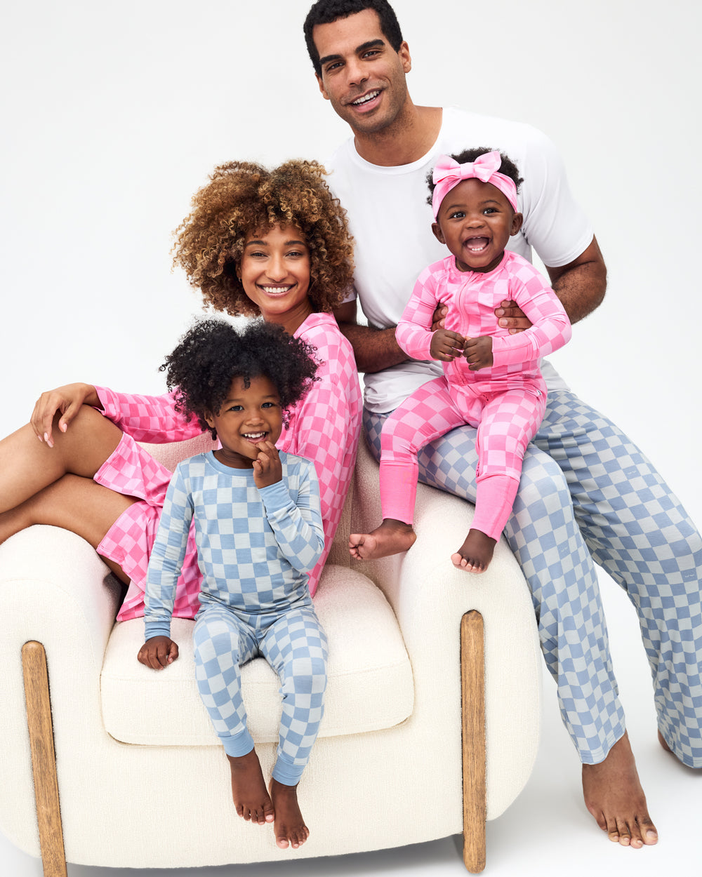 Family of four wearing matching Sweet Raspberry and Dusk Blue Checks pajamas