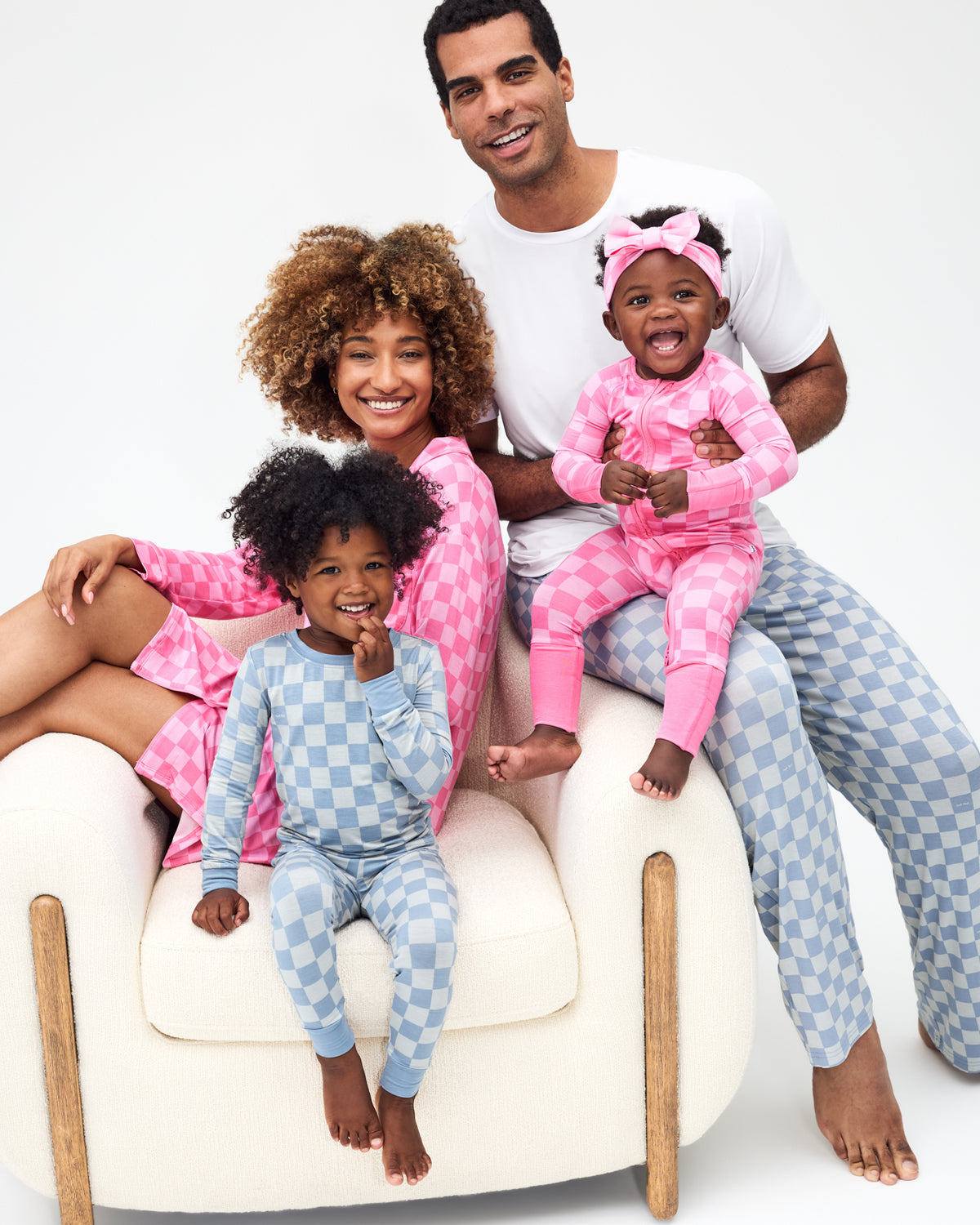 Family of four wearing matching Sweet Raspberry and Dusk Blue Checks pajamas