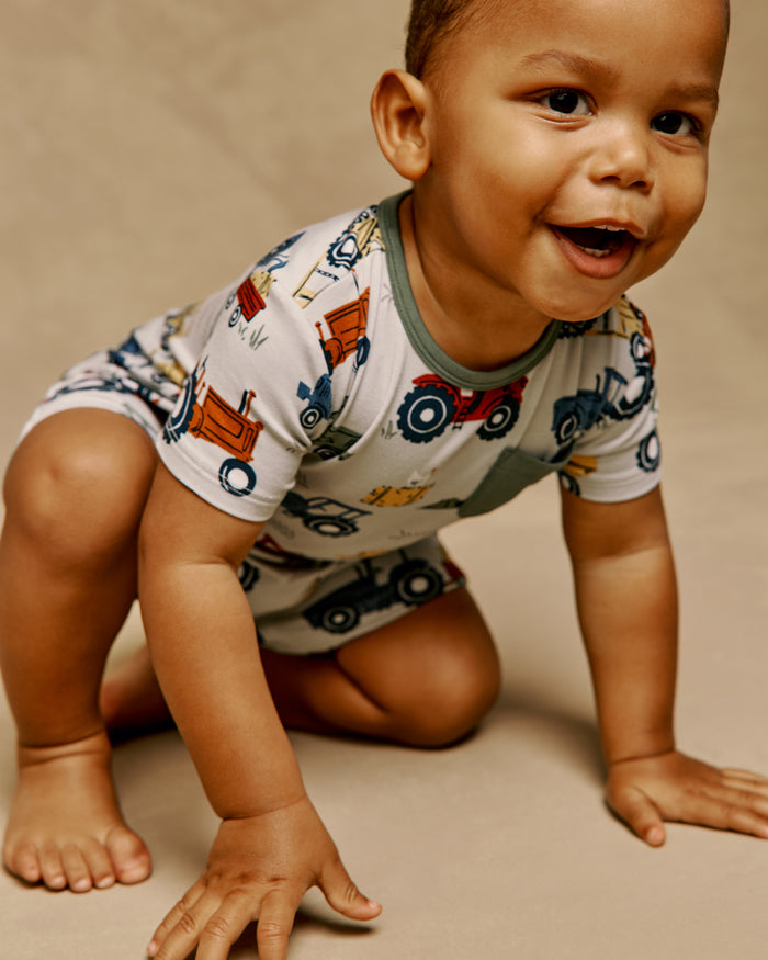 Crawling child wearing the Tractor Tales Pocket Shorty Romper