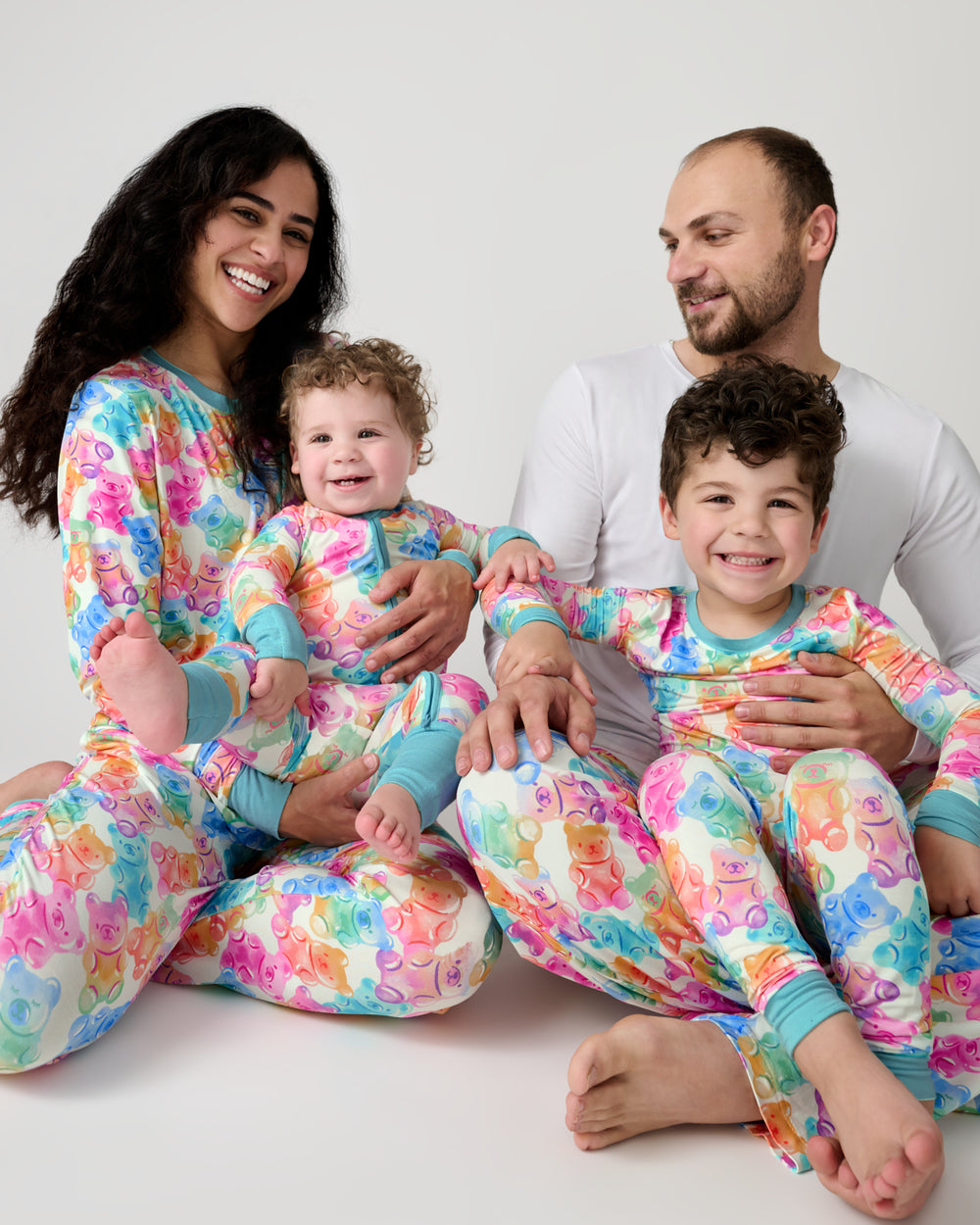 Family of four wearing matching Gummy Giggles Pajamas