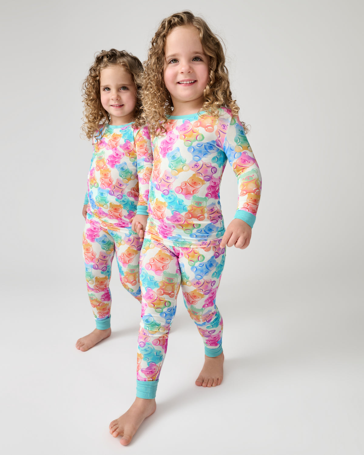 Two children wearing the Gummy Giggles Two-Piece Pajama Set