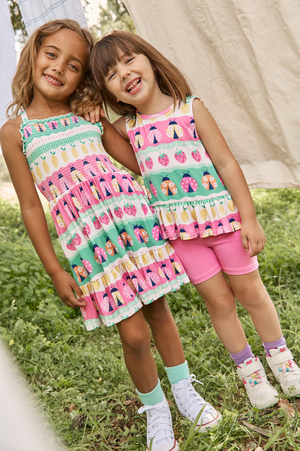 Two girls wearing Play styles from the Spring Capsule