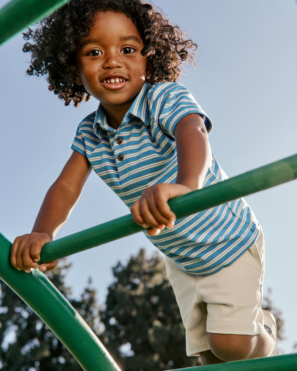 Boy wearing the Jay Blue Heather Stripes Polo Shirt on a playground