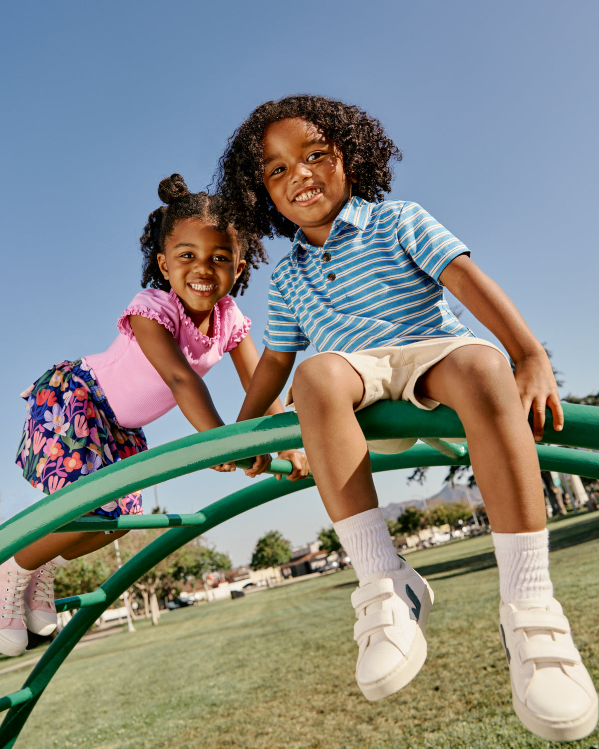 Two children wearing Back to School styles on a playground