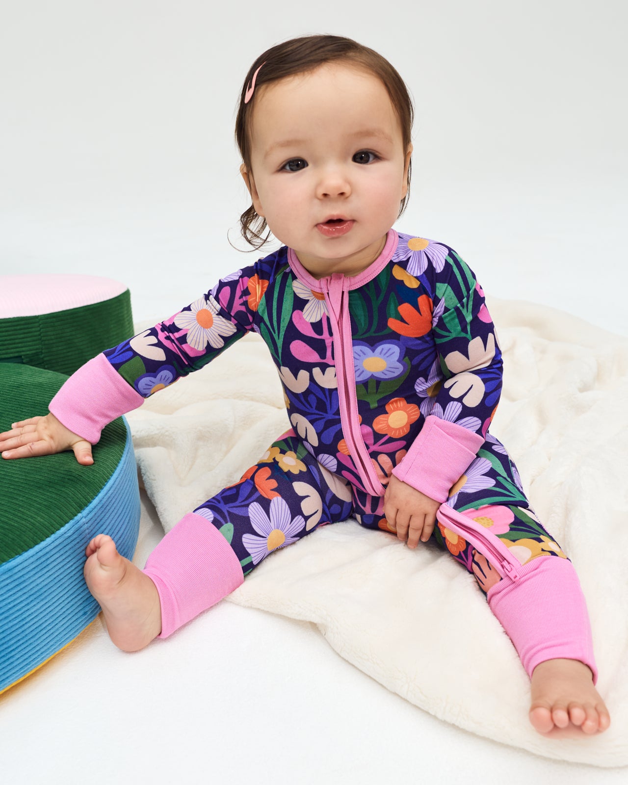 Sitting baby wearing the Wild Garden Zippy