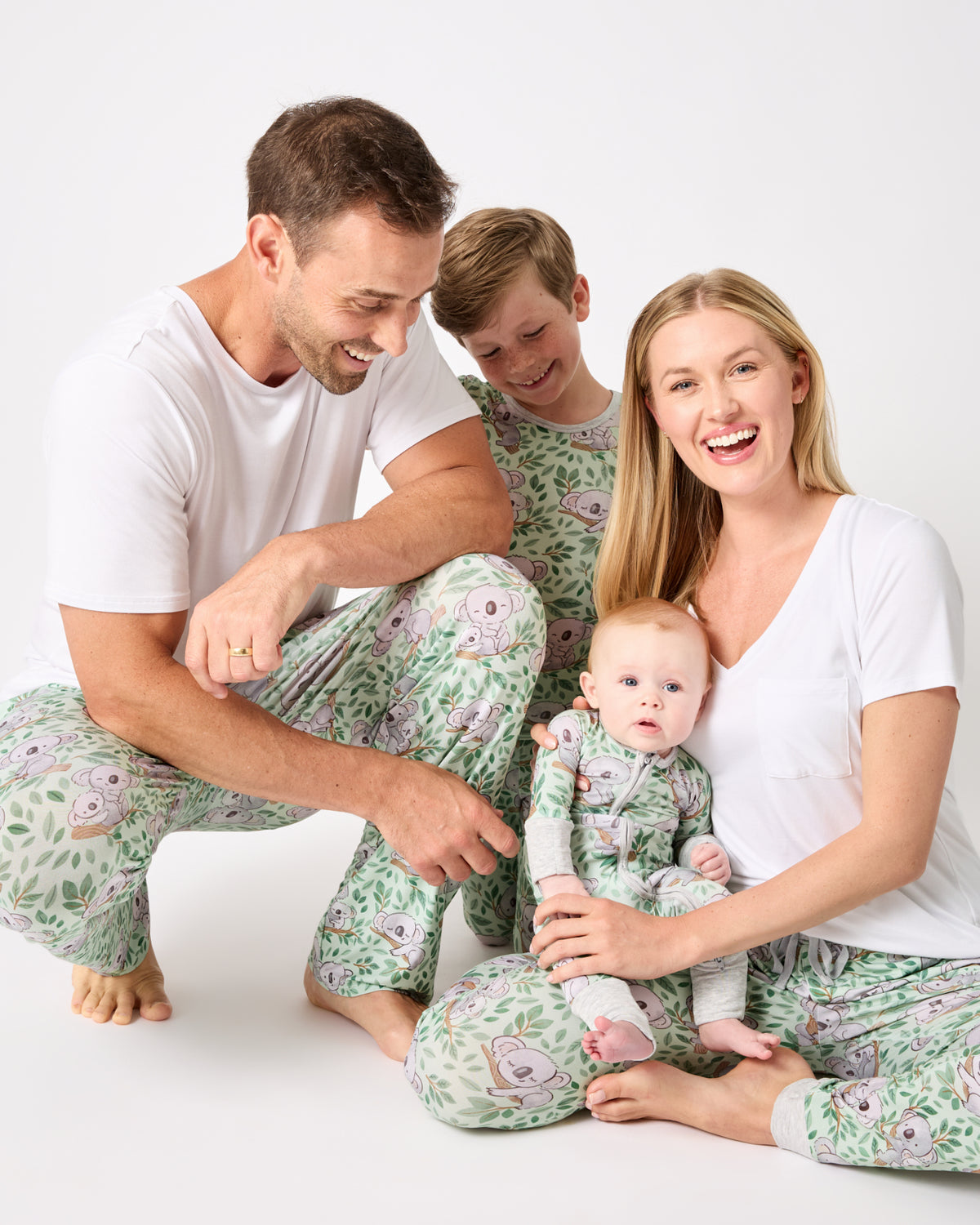 Family of four wearing matching Koala Cuddles Pajamas
