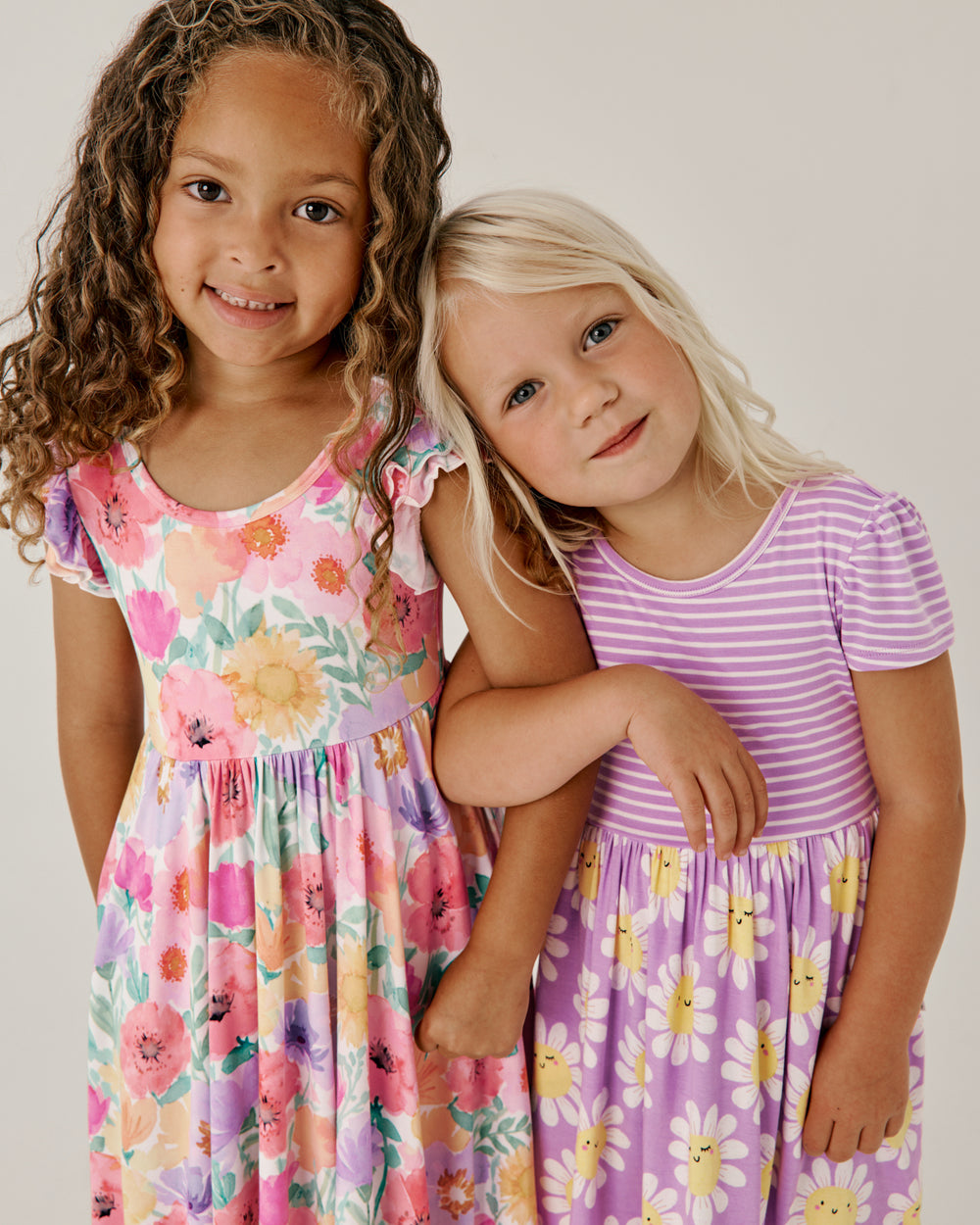 Two girls wearing styles from The Dress Shop