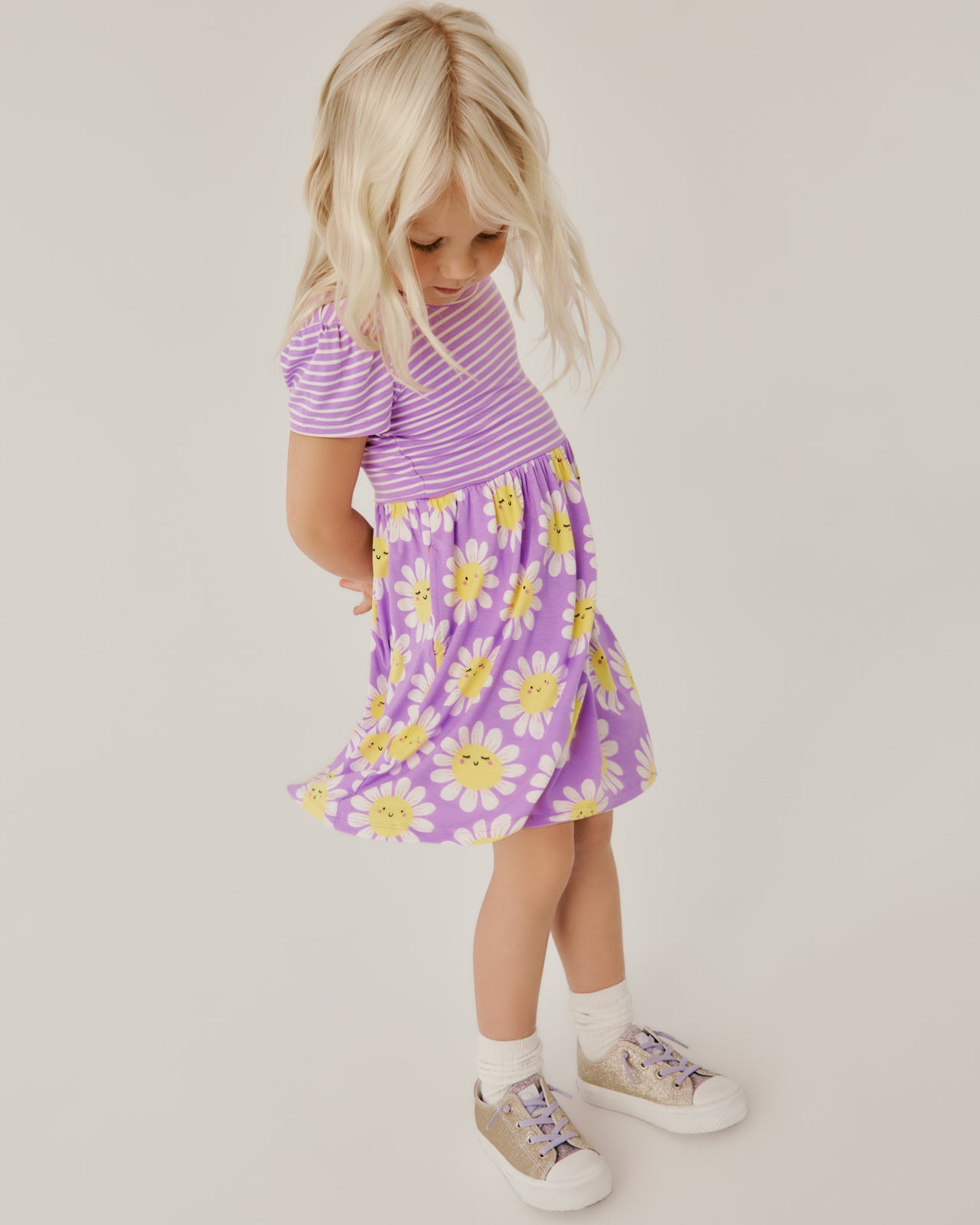 Girl twirling the skirt on the Flower Power Skater Dress