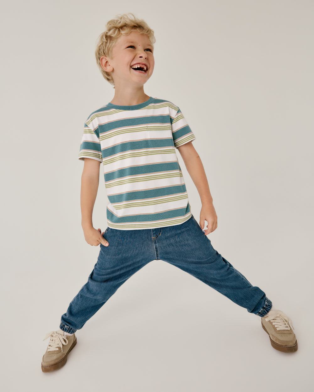 Boy wearing the Comet Stripes Relaxed Pocket Tee with denim joggers