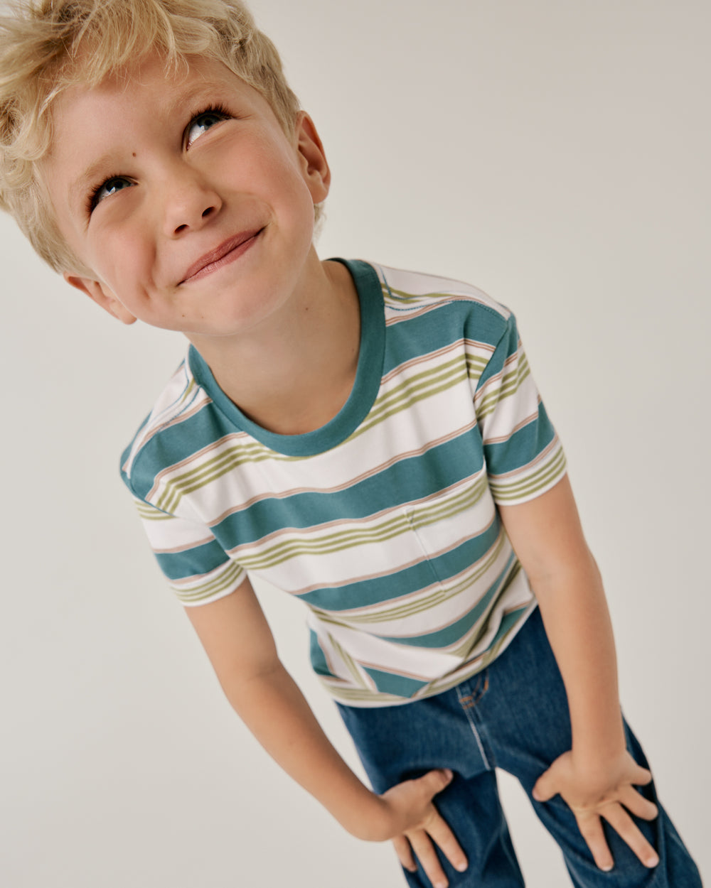 Close up of boy wearing the Comet Stripes Relaxed Pocket Tee