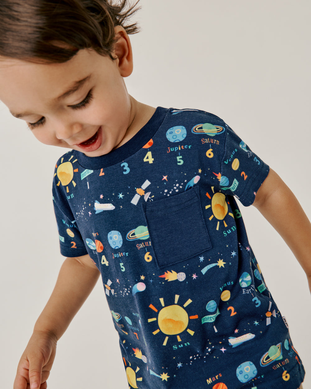 Close up of boy wearing the Solar Explorers Relaxed Pocket Tee