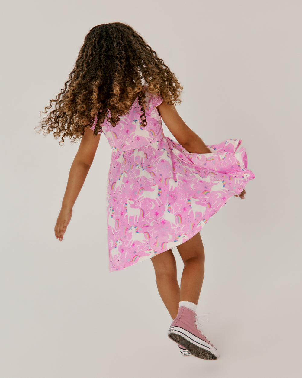 Twirling girl wearing the Unicorn Dance Flutter Twirl Dress