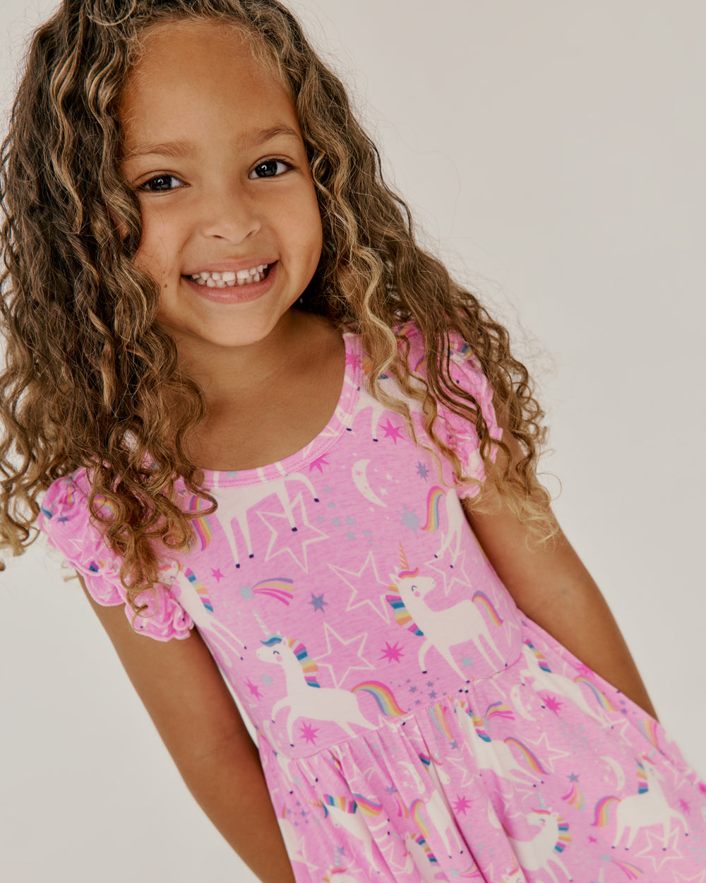 Close up of girl wearing the Unicorn Dance Flutter Twirl Dress