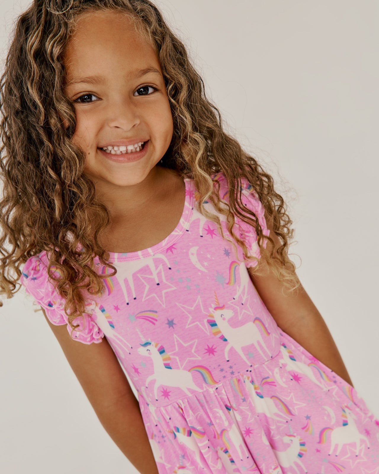 Close up of girl wearing the Unicorn Dance Flutter Twirl Dress
