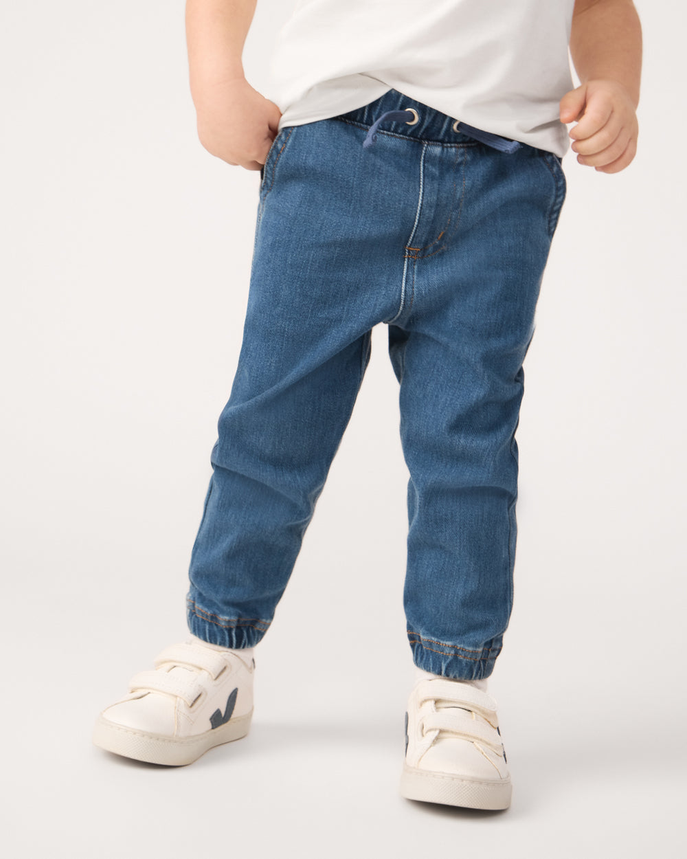 Close up of child wearing the Midwash Blue Denim Jogger