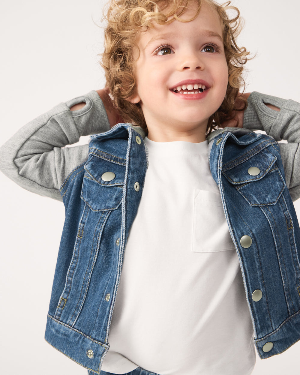 Boy wearing the Midwash Blue/Gray Denim Jacket layered over a white tee