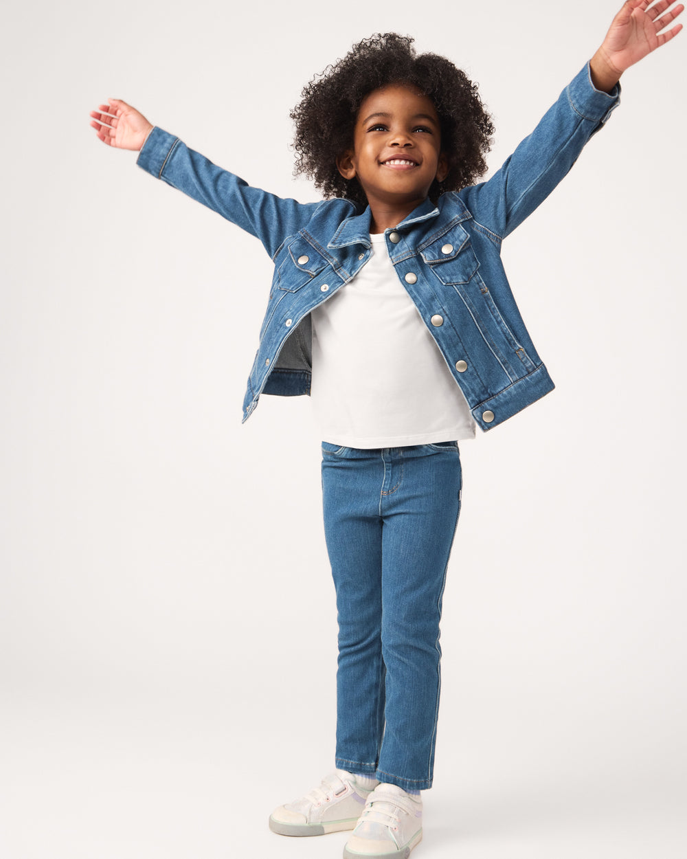 Girl wearing the Midwash Blue Denim Jegging with a white tee