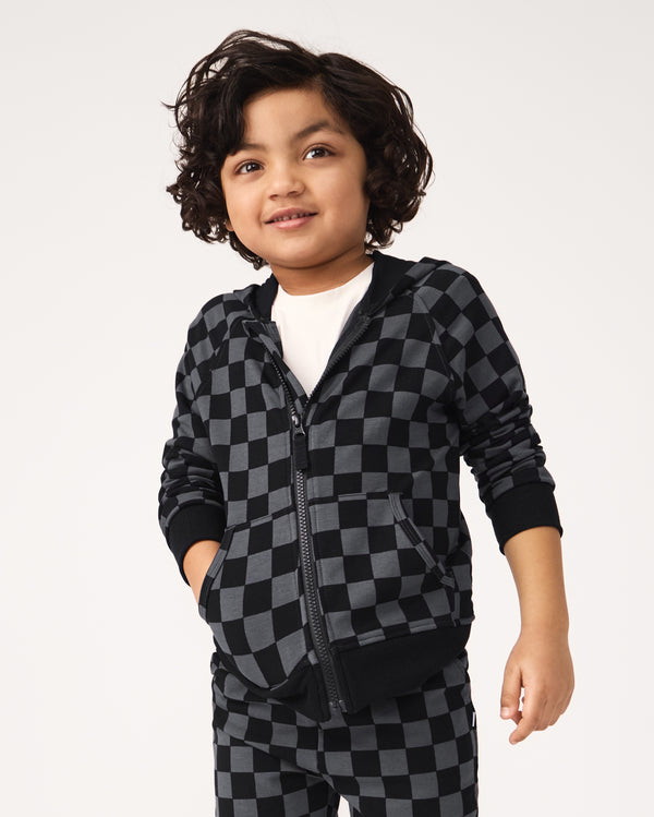 Boy wearing the Monochrome Checks Zip Hoodie over a white tee