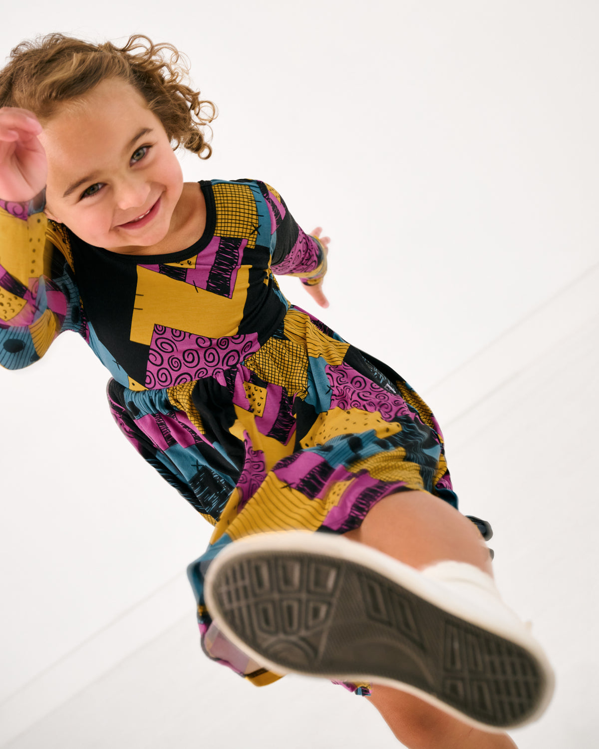 Child in motion wearing the Disney Sally's Patchwork Twirl Dress