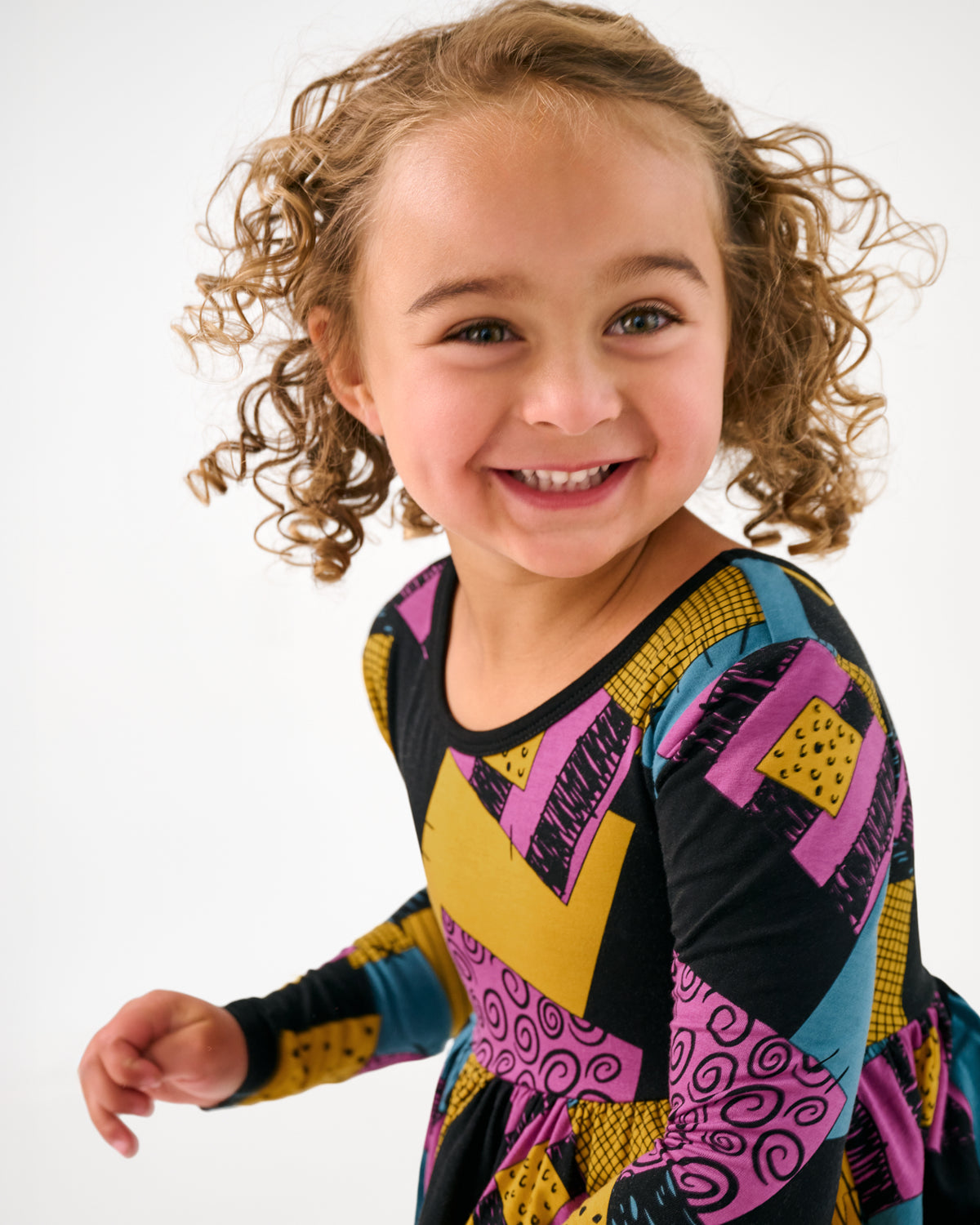 Close up of girl wearing the Disney Sally's Patchwork Twirl Dress