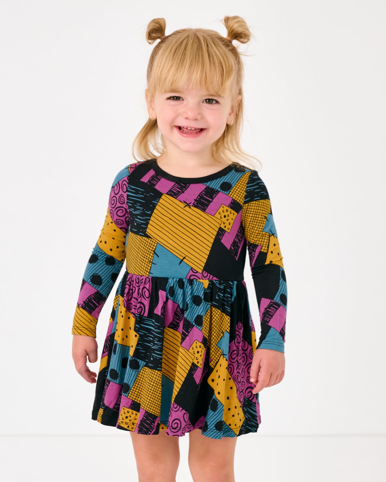 Standing girl wearing the Disney Sally's Patchwork Twirl Dress with Bodysuit
