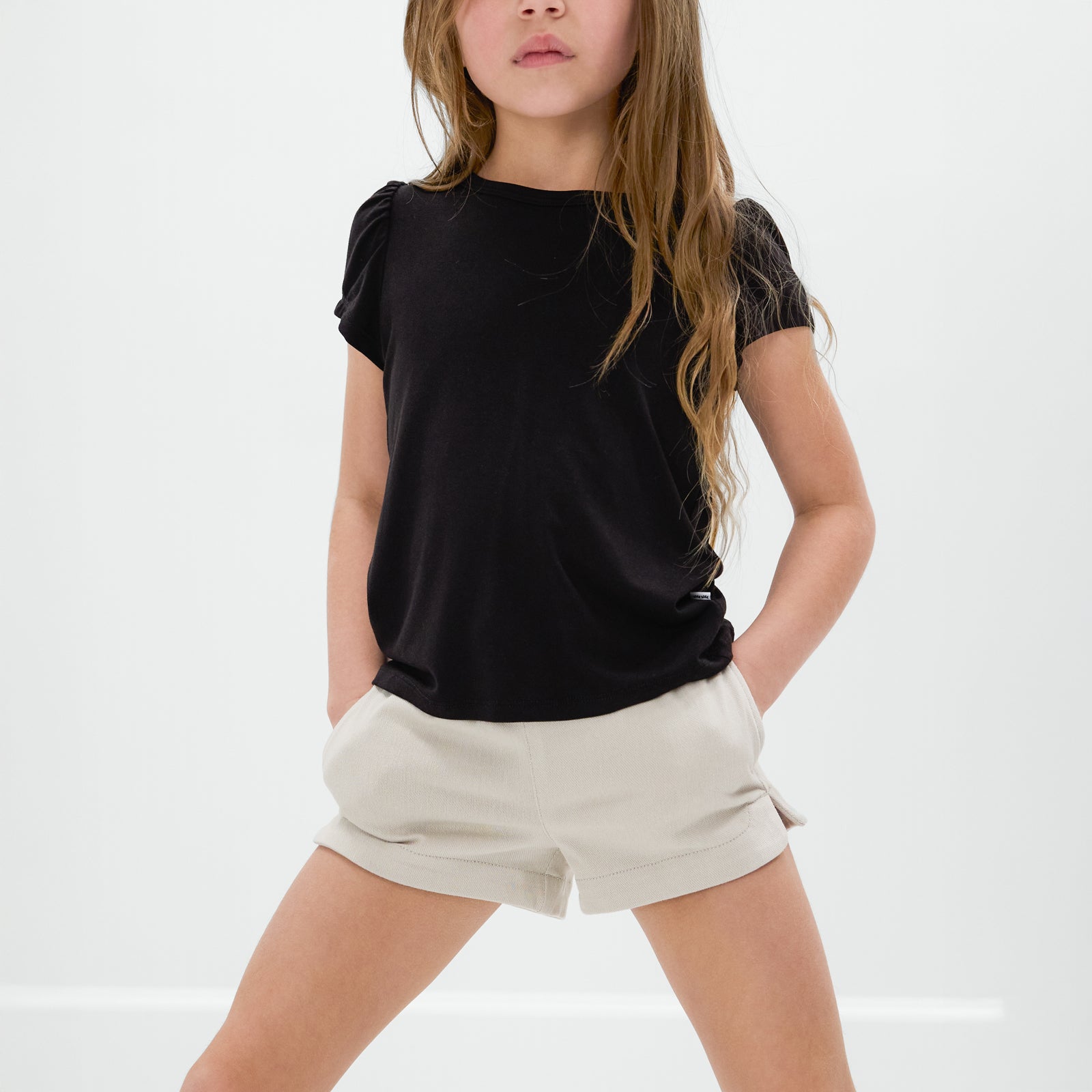 Child wearing the Sandstone Denim Shorts with a black bamboo tee