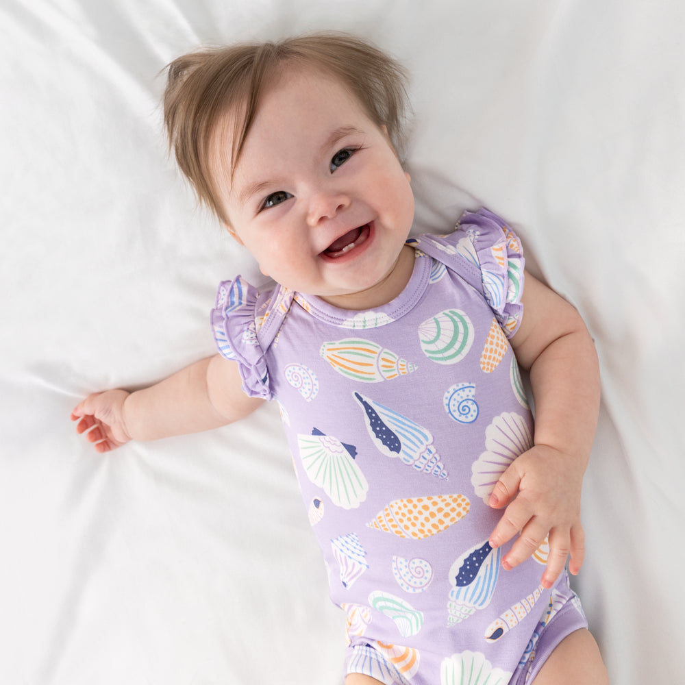 Aerial view of child wearing the Sandy Treasures Flutter Bodysuit
