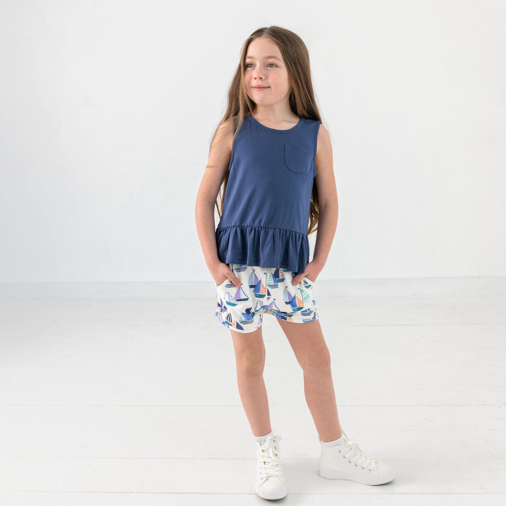 Standing child wearing the Seas The Day Dolphin Shorts
