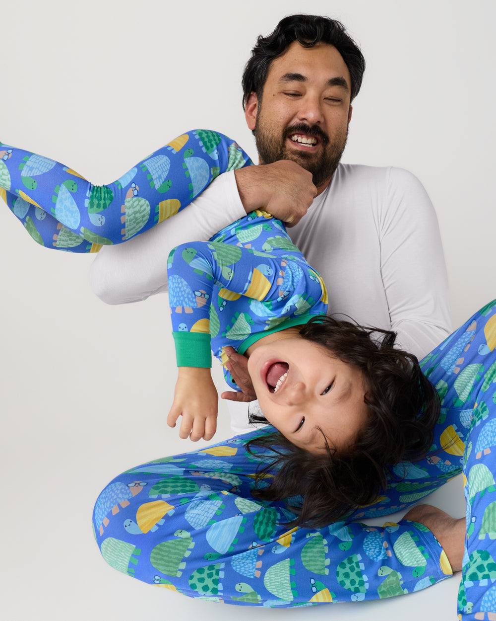 Father holding child wearing the Shell Parade Men's Pajama Pants