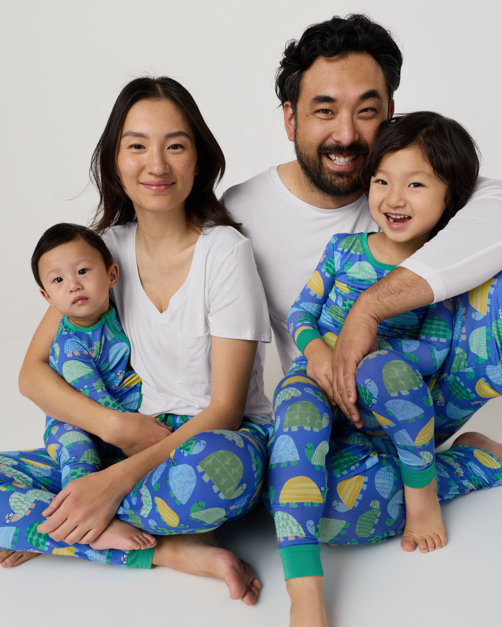 Family of four wearing matching Shell Parade Pajamas