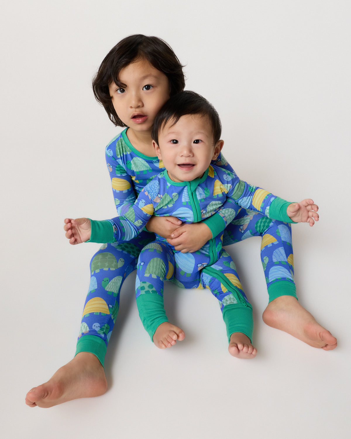 Two children wearing matching Shell Parade Pajamas