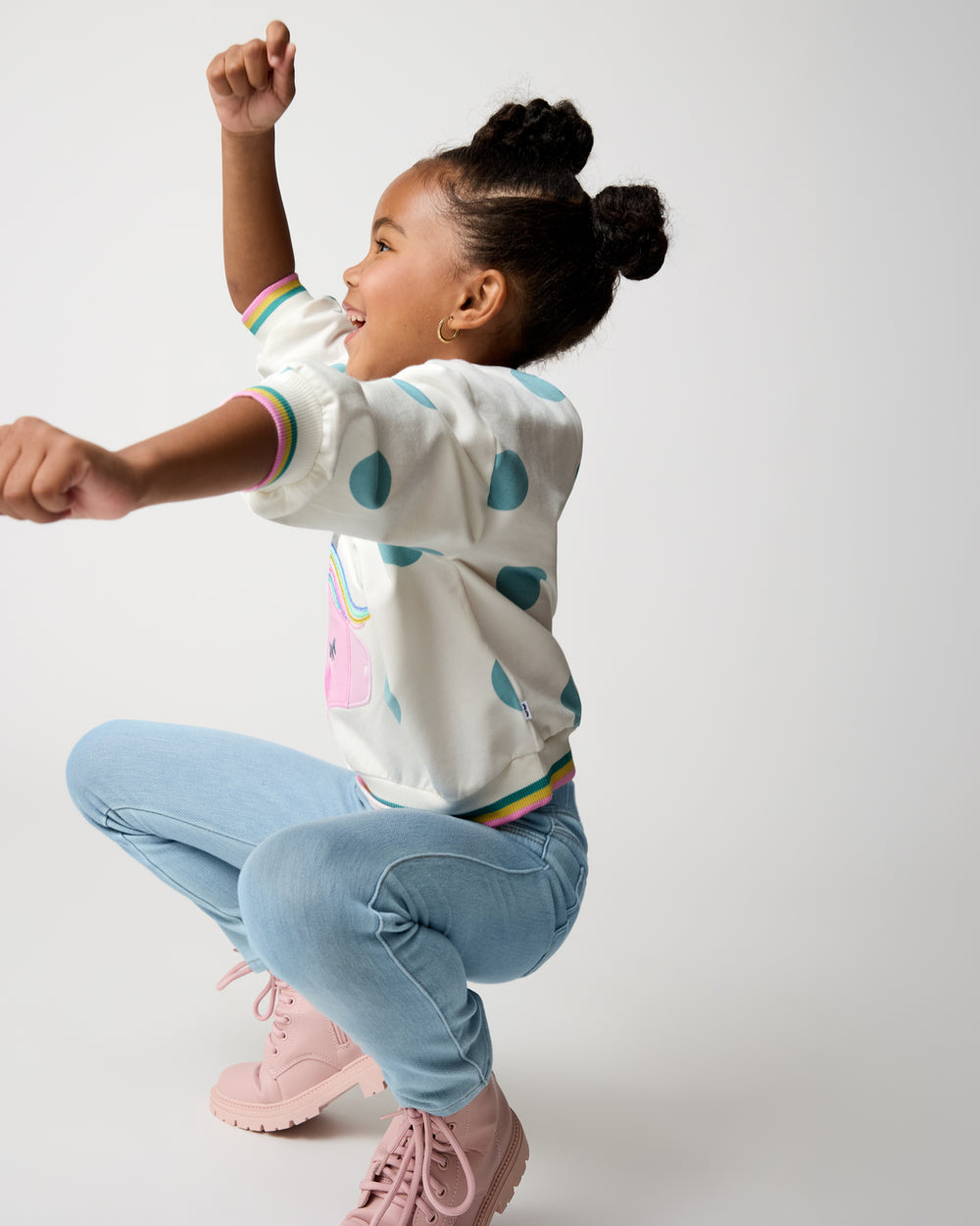 Dancing child wearing the Unicorn Drop Shoulder Crewneck
