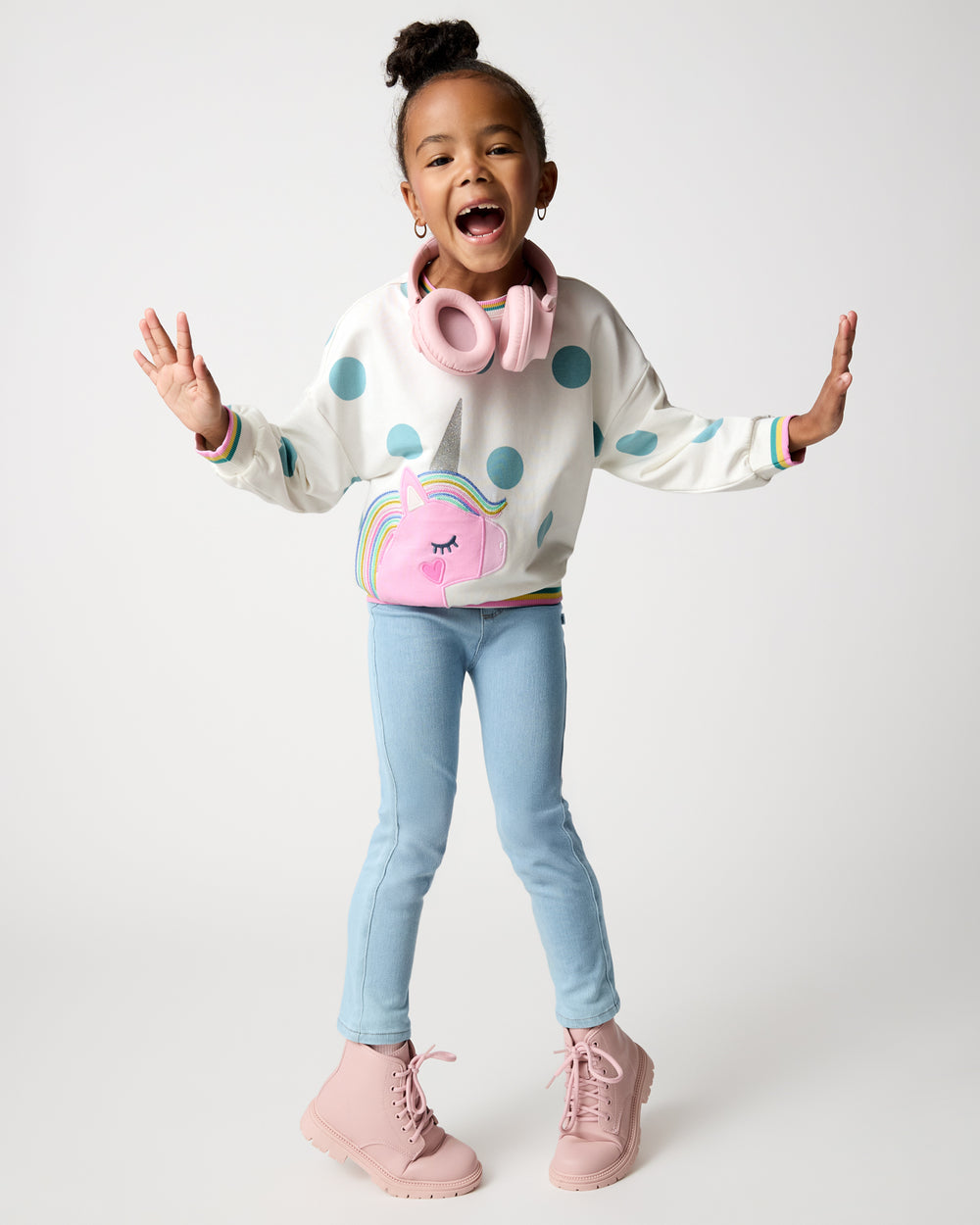 Posing girl wearing the Unicorn Drop Shoulder Crewneck with denim pants