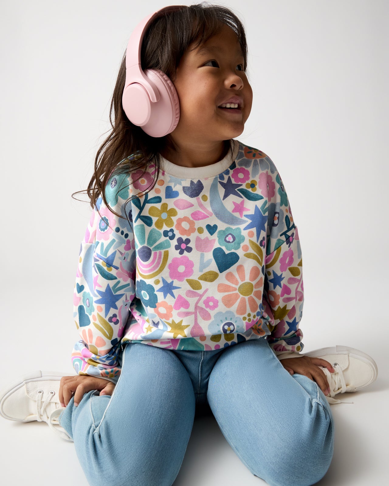 Girl wearing the Unicorn Blossoms Drop Shoulder Crewneck with blue denim pants