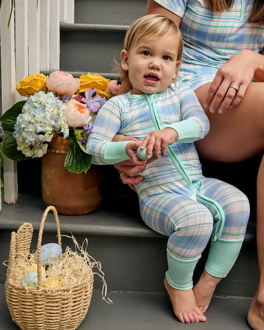 Baby sitting on a front porch wearing the Springtime Plaid Zippy