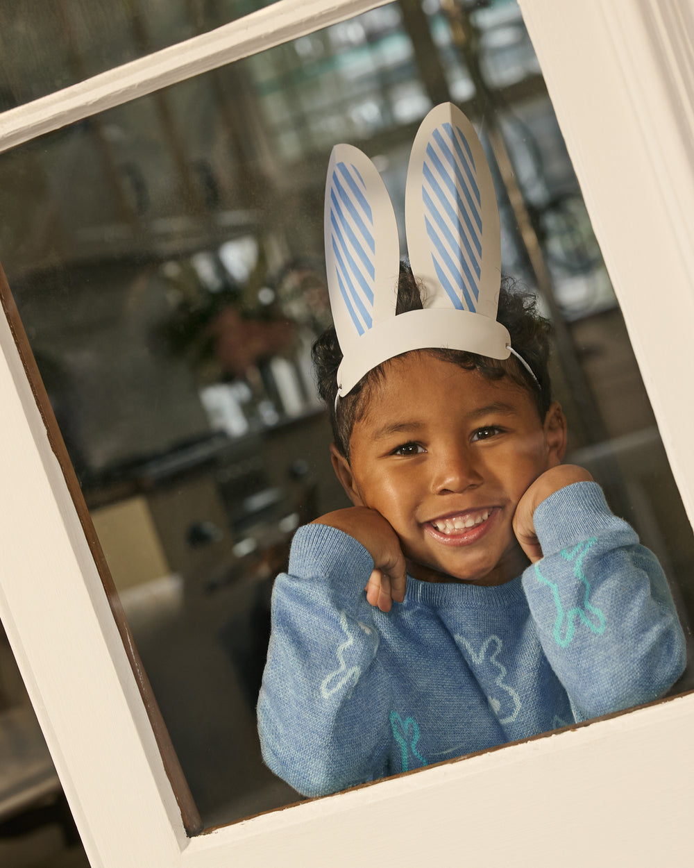 Boy wearing the Cozy Cottontails Sweater with Easter Bunny ears