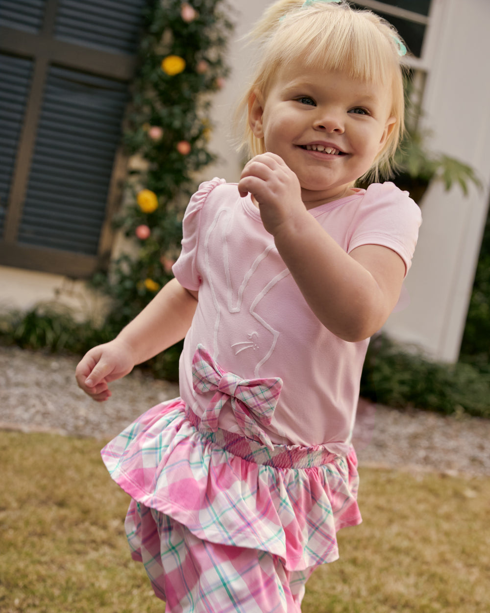 Running girl wearing the Springtime Plaid Tiered Skort