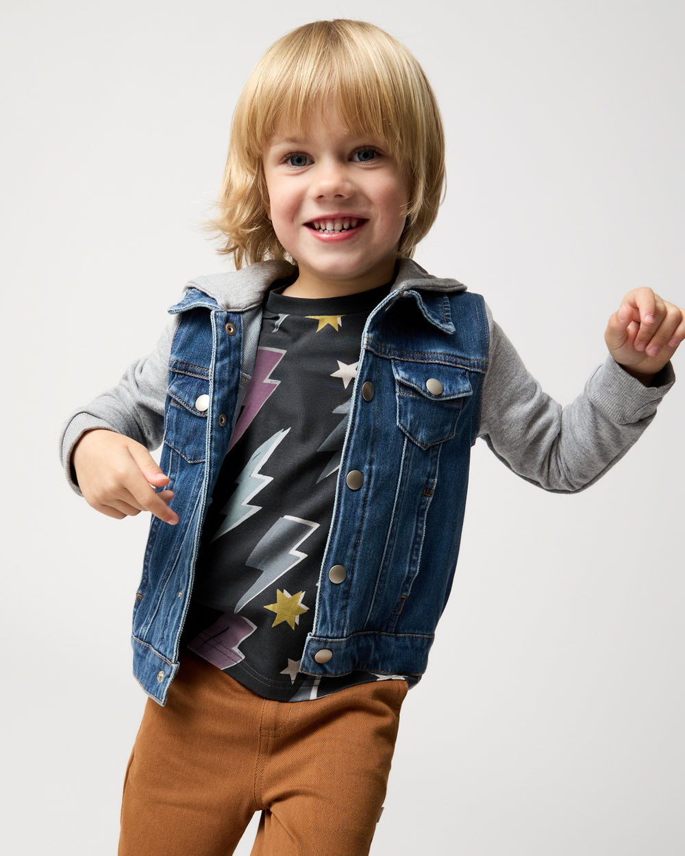 Child wearing the Rad Bolts Relaxed Tee layered under a trucker jacket