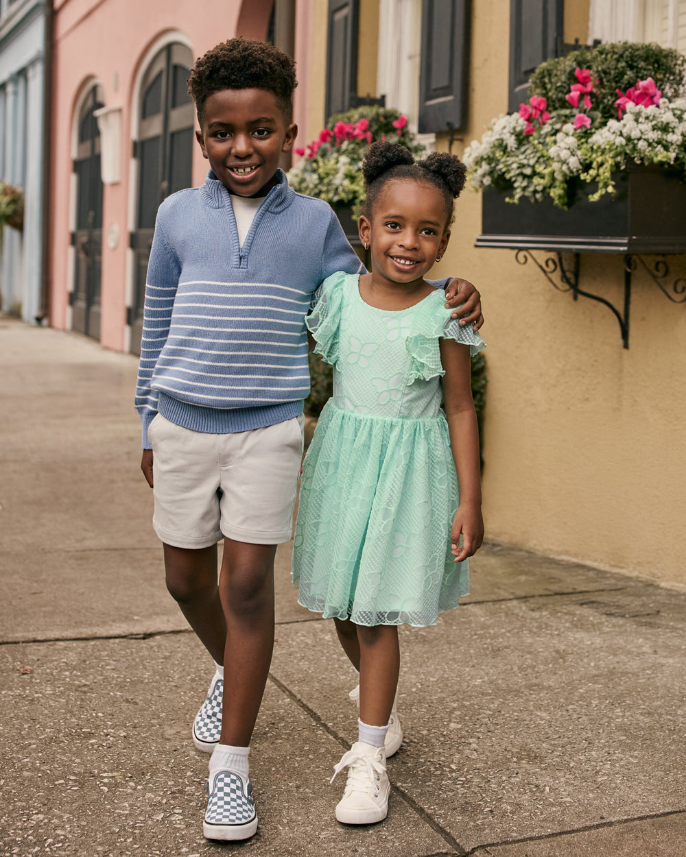 Two children wearing Easter Play styles with a cityscape in the background