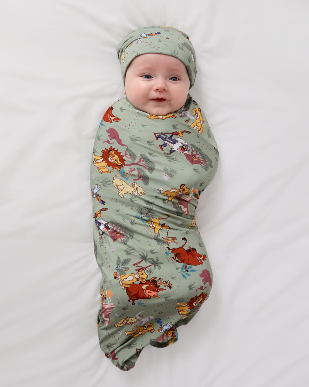 Aerial view of baby wearing the Simba's Safari Swaddle & Hat Set