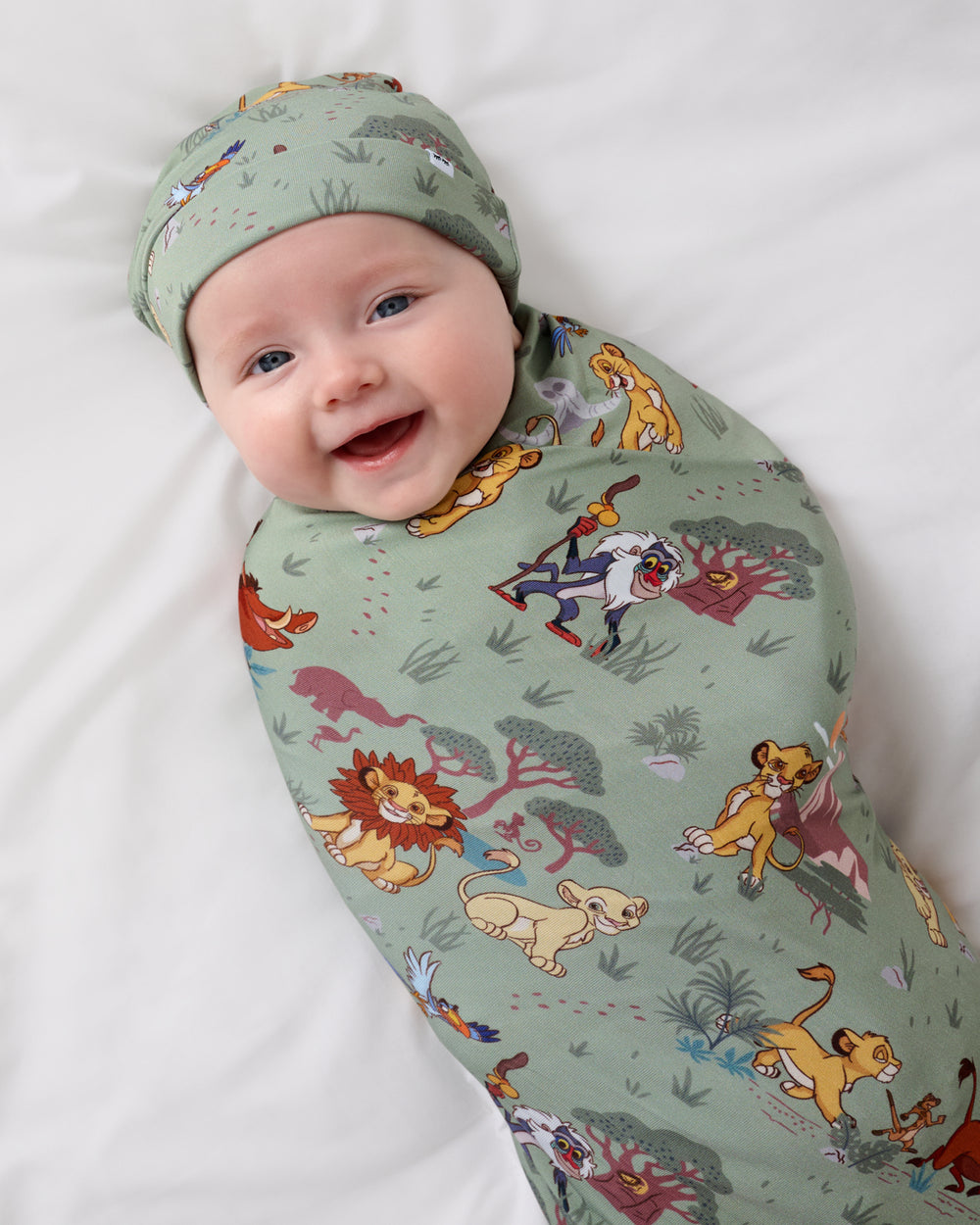 Close up aerial view of baby wearing the Simba's Safari Swaddle & Hat Set