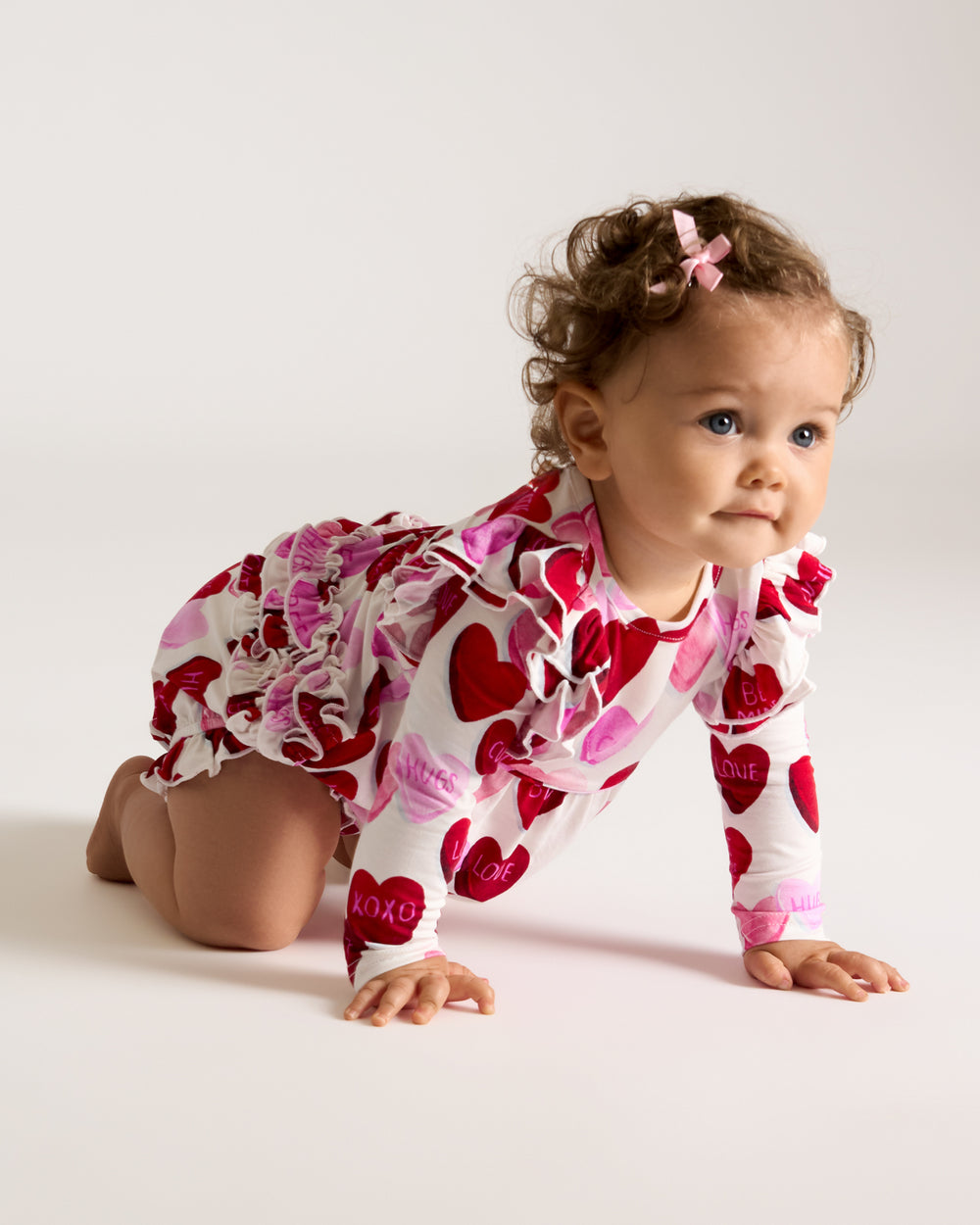 Crawling baby wearing the Candy Cuties Bubble Romper