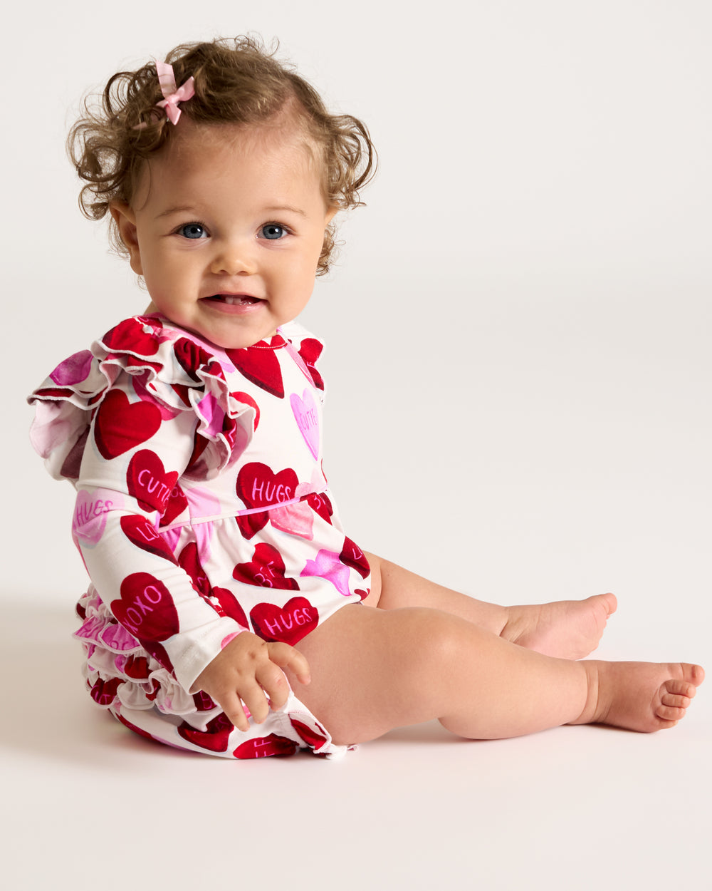 Sitting baby wearing the Candy Cuties Bubble Romper