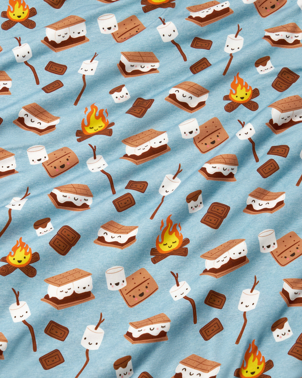 A light blue fabric with a repeating pattern of cartoon s'mores, marshmallows on sticks, chocolate pieces, and campfires.